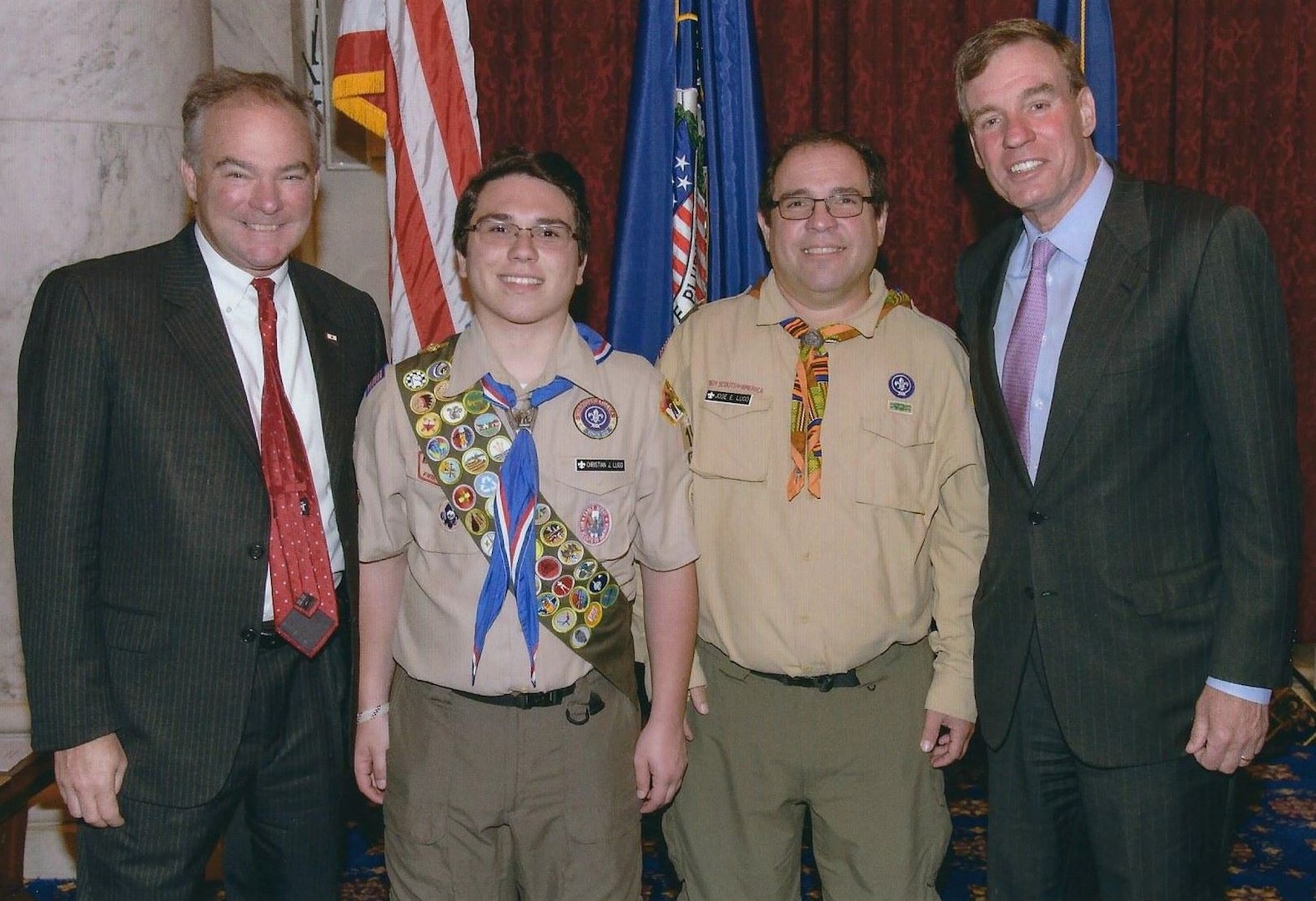 IMAGE: WASHINGTON - NSWC Dahlgren Division engineer Jose Lugo and his son Christian Lugo - an Eagle Scout from King George Boy Scout Troop 191 - are pictured with U.S. Senators Tim Kaine (D-Va.) and Mark Warner (D-Va.) at a recent Scouting recognition event held in the Russell Senate Office Building.