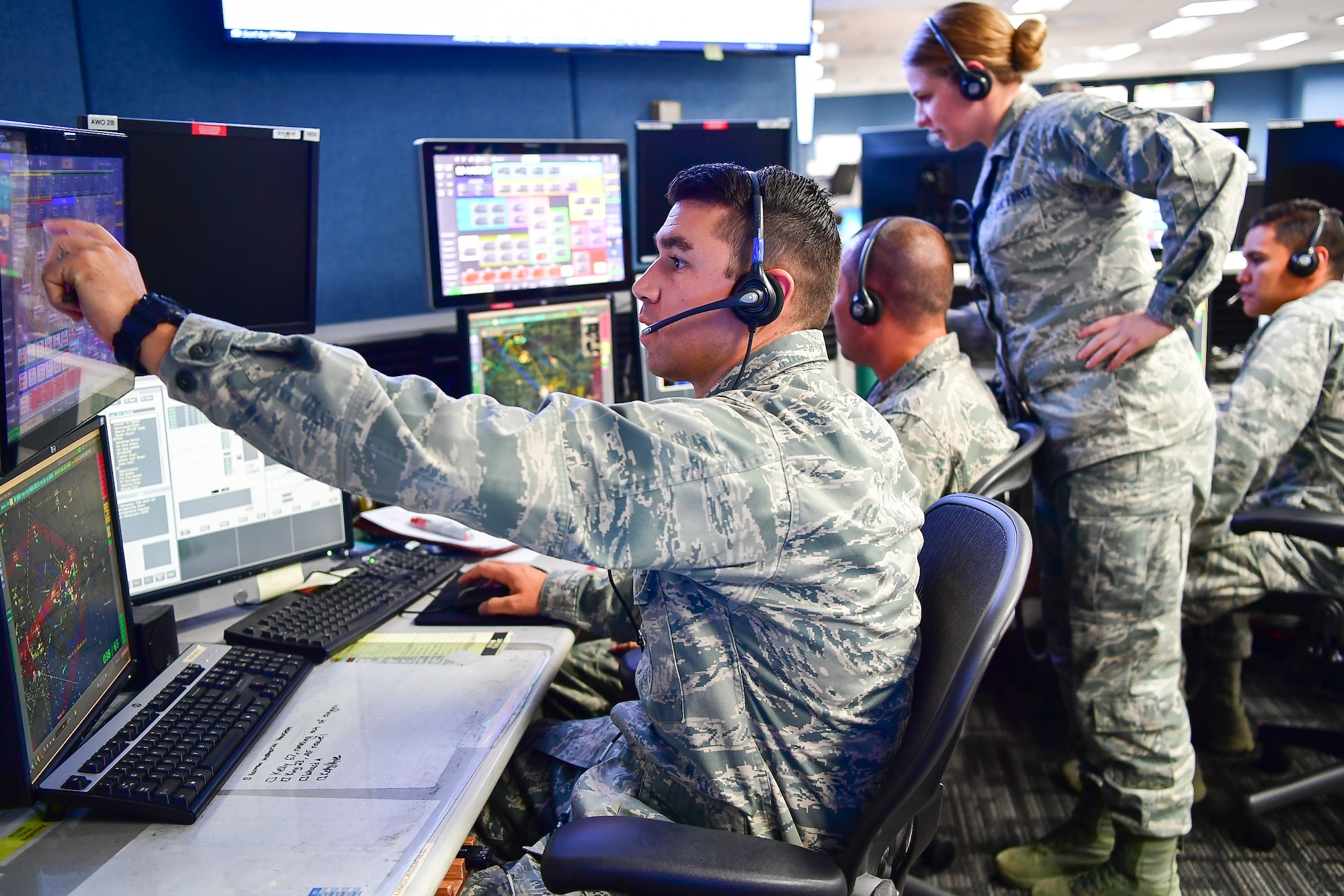The WADS team of Capt. Nicholas Rhodes (from left to right), Maj. Matthew Horrocks, Staff Sgt. Kayla Sharpe, and Capt. Gregory Firestone coordinate expeditiously with an orbiting AWACS aircraft and joint terminal attack controllers on the ground to assist with aviation rescue of  victims of Hurricane Harvey in areas surrounding Houston, Texas.