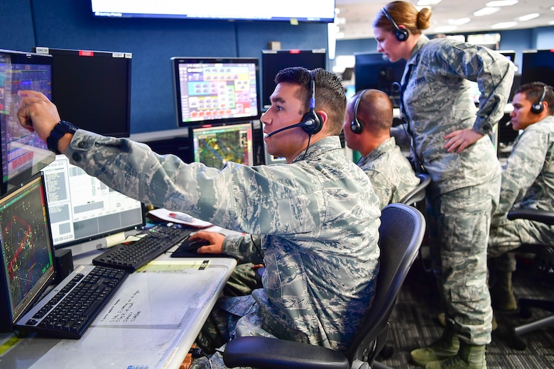 The WADS team of Capt. Nicholas Rhodes (from left to right), Maj. Matthew Horrocks, Staff Sgt. Kayla Sharpe, and Capt. Gregory Firestone coordinate expeditiously with an orbiting AWACS aircraft and joint terminal attack controllers on the ground to assist with aviation rescue of  victims of Hurricane Harvey in areas surrounding Houston, Texas.