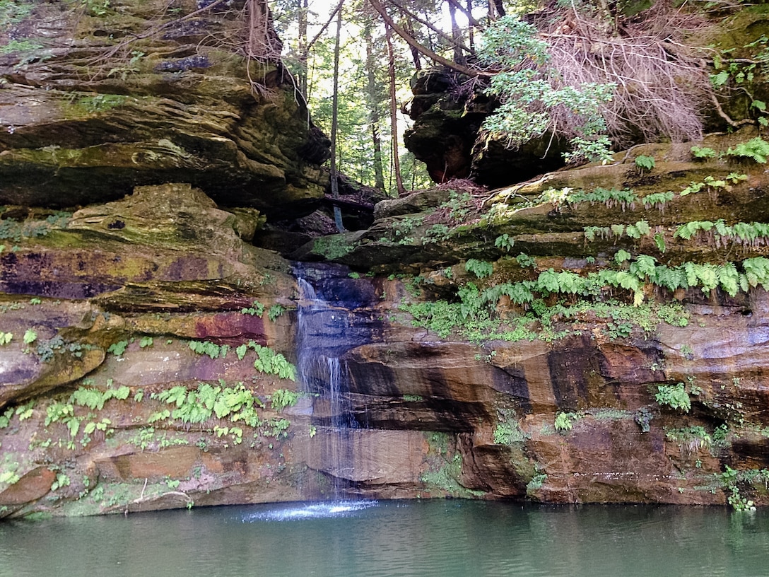 A waterfall flows over the rock bluffs after recent rains at Piney Creek, Nolin River Lake, Bee Spring, Kentucky.