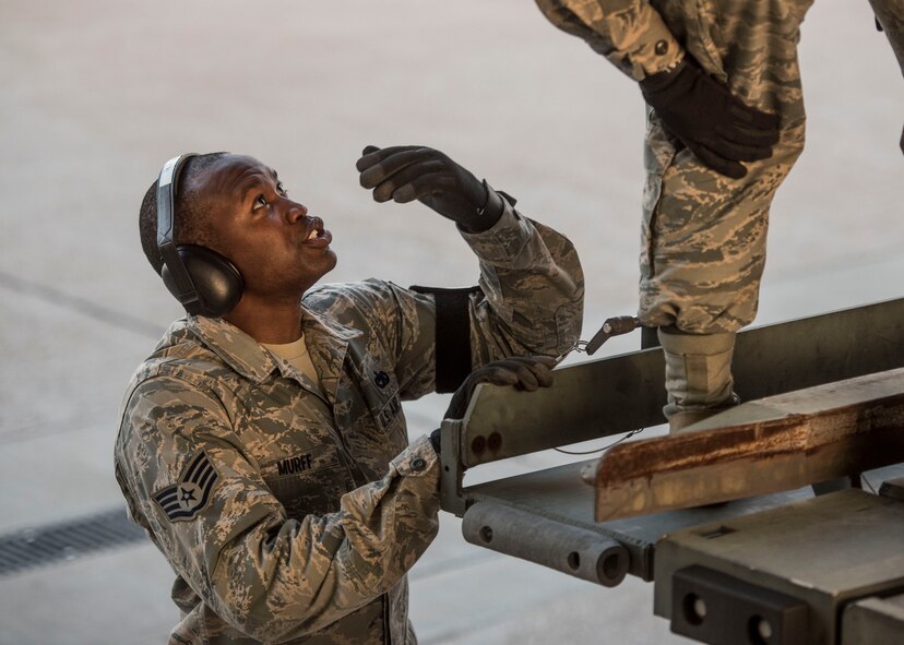 Staff Sgt. Kaleem Murff, 375th Logistics Readiness Squadron, speaks to Senior Airman Meghan Kalisek, 375th LRS, as the team loads cargo onto a C-17 Globemaster III following the mobilization of the 375th Aeromedical Evacuation Squadron, which will provide Hurricane Harvey medical aid for high-priority patients, Scott Air Force Base, Ill., Aug. 30, 2017.