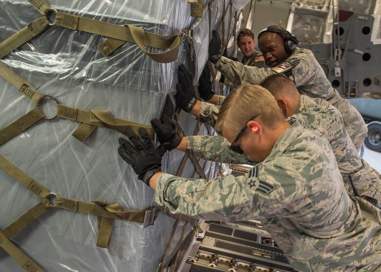 Members of the 375th Logistics Readiness Squadron load disaster relief cargo onto a C-17 Globemaster III following the mobilization of the 375th Aeromedical Evacuation Squadron, who will provide Hurricane Harvey medical aid for high-priority patients, Scott Air Force Base, Ill., Aug. 30, 2017