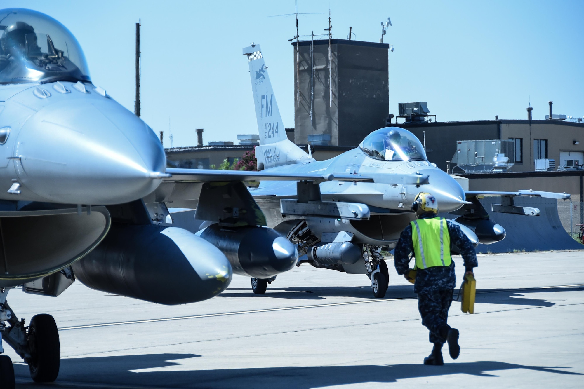 A Sailor runs to secure an F-16 Fighting Falcon from Homestead Air Reserve Base, Florida, Sept. 6, 2017, at Naval Air Station Fort Worth Joint Reserve Base, Texas. Fourteen aircraft relocated here today due to Hurricane Irma’s anticipated landfall. The base serves as a safe haven for military aircraft that are in the path of the hurricane. (U.S. Air Force photo by Maj. Candice Allen)
