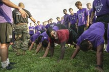 Students with the Grand Island Senior High School football team complete a workout led by Marine Corps recruiters in Grand Island, Neb. Aug. 2, 2017. The camps allow Marines to teach the importance of our core values to young athletes across the nation.