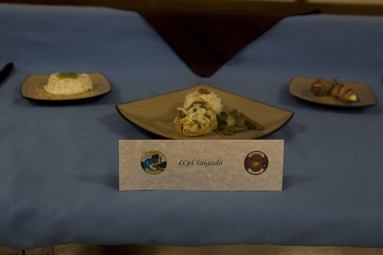 U.S. Marine Corps Lance Cpl. Luke Salgado, a food service specialist with 1st Battalion, 12th Marine Regiment, displays his meal prepared for the Chef of the Quarter cook-off competition at Anderson Hall aboard Marine Corps Base Hawaii, August 23, 2017. After a series of evaluations to include a 50-question written test, an oral board and a uniform inspection, the U.S. Marines with top three highest combined scores were selected to be a part of the cook-off. The competitors used chicken, curry, cream cheese and kiwi fruit as items for their appetizer, entrée and desserts. (U.S. Marine Corps photo by Cpl. Zachary Orr)