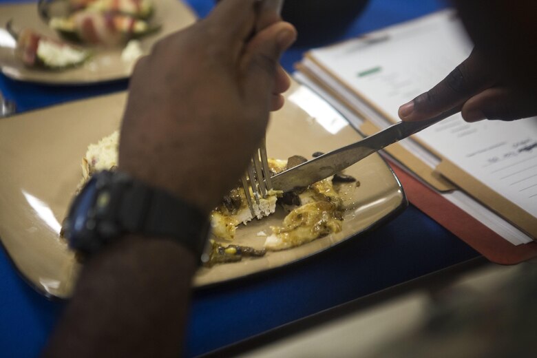 U.S. Marine Corps Pvt. Courtney Bradley, an administrative specialist with Installation Personnel Administration Center, Marine Corps Base Hawaii (MCBH), samples food during the Chef of the Quarter cook-off competition at Anderson Hall aboard MCBH, August 23, 2017. After a series of evaluations to include a 50-question written test, an oral board and a uniform inspection, the U.S. Marines with top three highest combined scores were selected to be a part of the cook-off. The competitors used chicken, curry, cream cheese and kiwi fruit as items for their appetizer, entrée and desserts. (U.S. Marine Corps photo by Cpl. Zachary Orr)