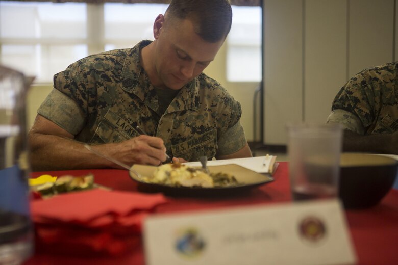 U.S. Marine Corps Gunnery Sgt. Roy Lackey, the engineer equipment chief with Marine Wing Support Detachment 24 and a judge for the cook-off, writes down his rating on a meal during the Chef of the Quarter cook-off competition at Anderson Hall aboard Marine Corps Base Hawaii, August, 23, 2017. After a series of evaluations to include a 50-question written test, an oral board and a uniform inspection, the U.S. Marines with top three highest combined scores were selected to be a part of the cook-off. The competitors used chicken, curry, cream cheese and kiwi fruit as items for their appetizer, entrée and desserts. (U.S. Marine Corps photo by Cpl. Zachary Orr)