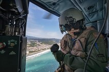 Tech Sgt. Nicholas Poe, 459th Airlift Squadron special missions aviator, communicates with UH-1N crew members