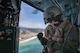 Tech Sgt. Nicholas Poe, 459th Airlift Squadron special missions aviator, communicates with UH-1N crew members over Sagami Bay, Japan, during the 2017 Big Rescue Kanagawa Disaster Prevention Drill, Sept. 1, 2017. Airmen of the 459 AS demonstrated their rescue capabilities among local participants during the Big Rescue Kanagawa for the first time. (U.S. Air Force photo by Yasuo Osakabe)