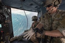 Staff Sgt. Justin Bender, 374th Operations Support Squadron survival, evasion, resistance and escape specialist, wears gloves over Sagami Bay