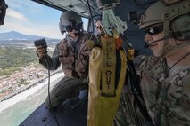 Tech. Sgt. Nicholas Poe, 459th Airlift Squadron special missions aviator, and Staff Sgt. Justin Bender, 374th Operations Support Squadron survival, evasion, resistance and escape specialist, check a forest penetrator