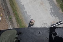 Staff Sgt. Justin Bender, 374th Operations Support Squadron survival, evasion, resistance and escape specialist, descends on a forest penetrator