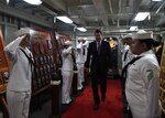 William F. Hagerty, U.S. ambassador to Japan, walks through side boys on the ceremonial quarterdeck aboard the Navy's forward-deployed aircraft carrier, USS Ronald Reagan (CVN 76). Hagerty met with senior leadership and toured the ship during his first visit to Ronald Reagan since taking the office of U.S. ambassador to Japan in July. Ronald Reagan, the Navy’s forward-deployed aircraft carrier, provides a combat-ready force that protects and defends the collective maritime interests of the U.S. and its allies and partners in the Indo-Asia-Pacific region.