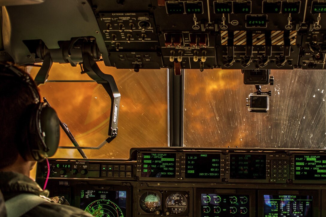 Flames and smoke are visible from the cockpit of an aircraft.