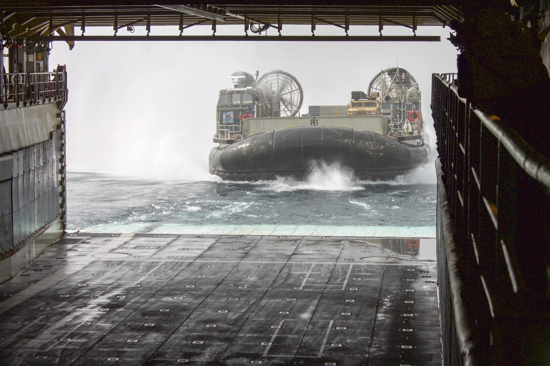 A landing craft, air cushion operated by Sailors of Assault Craft Unit 5 enters the well deck of the amphibious dock landing ship USS Pearl Harbor (LSD 52) while conducting amphibious operations in support of Alligator Dagger. Alligator Dagger is a dedicated, unilateral combat rehearsal led by Naval Amphibious Force, Task Force 51/5th Marine Expeditionary Brigade, in which combined Navy and Marine Corps units of the America Amphibious Ready Group and embarked 15th Marine Expeditionary Unit are to practice, rehearse and exercise integrated capabilities that are available to U.S. Central Command both afloat and ashore.