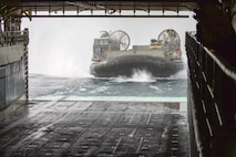 A landing craft, air cushion operated by Sailors of Assault Craft Unit 5 enters the well deck of the amphibious dock landing ship USS Pearl Harbor (LSD 52) while conducting amphibious operations in support of Alligator Dagger. Alligator Dagger is a dedicated, unilateral combat rehearsal led by Naval Amphibious Force, Task Force 51/5th Marine Expeditionary Brigade, in which combined Navy and Marine Corps units of the America Amphibious Ready Group and embarked 15th Marine Expeditionary Unit are to practice, rehearse and exercise integrated capabilities that are available to U.S. Central Command both afloat and ashore.