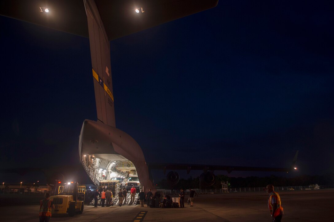 Air Force airmen unload supplies off from a C-17 Globemaster III during a hurricane relief mission to prepare for Hurricane Irma