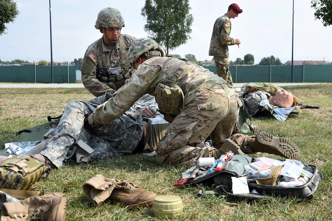 Soldiers provide medical aid to a mock casualty