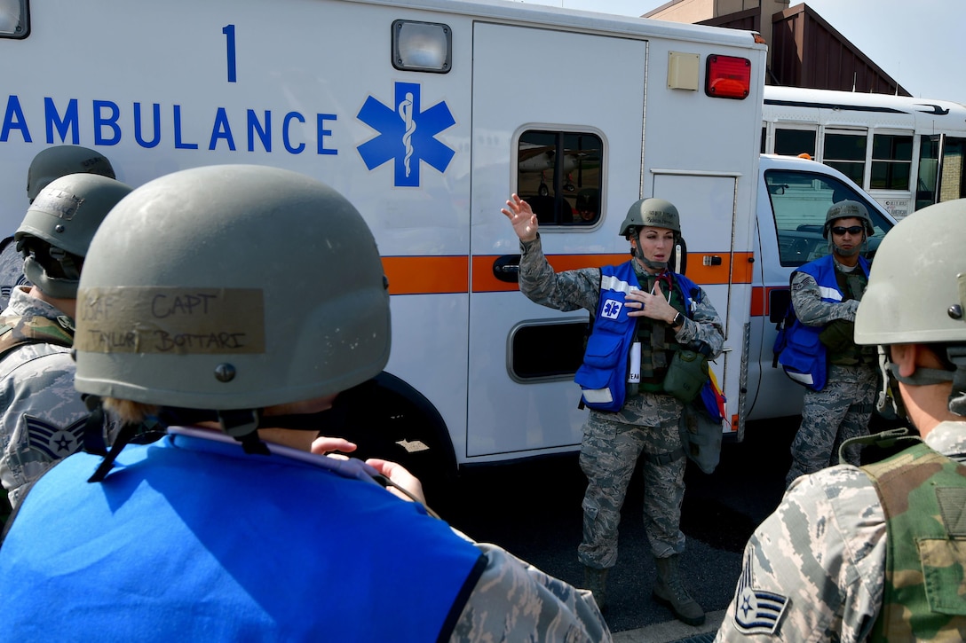 A member of the Air Force speaks while standing next to an ambulance.