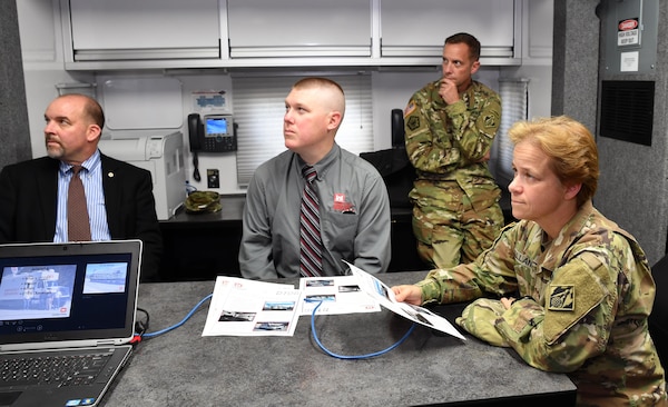 South Atlantic Division Commander Brig. Gen. Diana Holland and district officials received a briefing on Mobile District Deployable Tactical Operation System, or DTOS, capabilities by Terrell Bosarge, DTOS national team leader, not pictured. From left are: Eric North, district training officer; Col. James DeLapp, district commander; and Brig. Gen. Diana Holland, division commander. (Photo by John Barker)