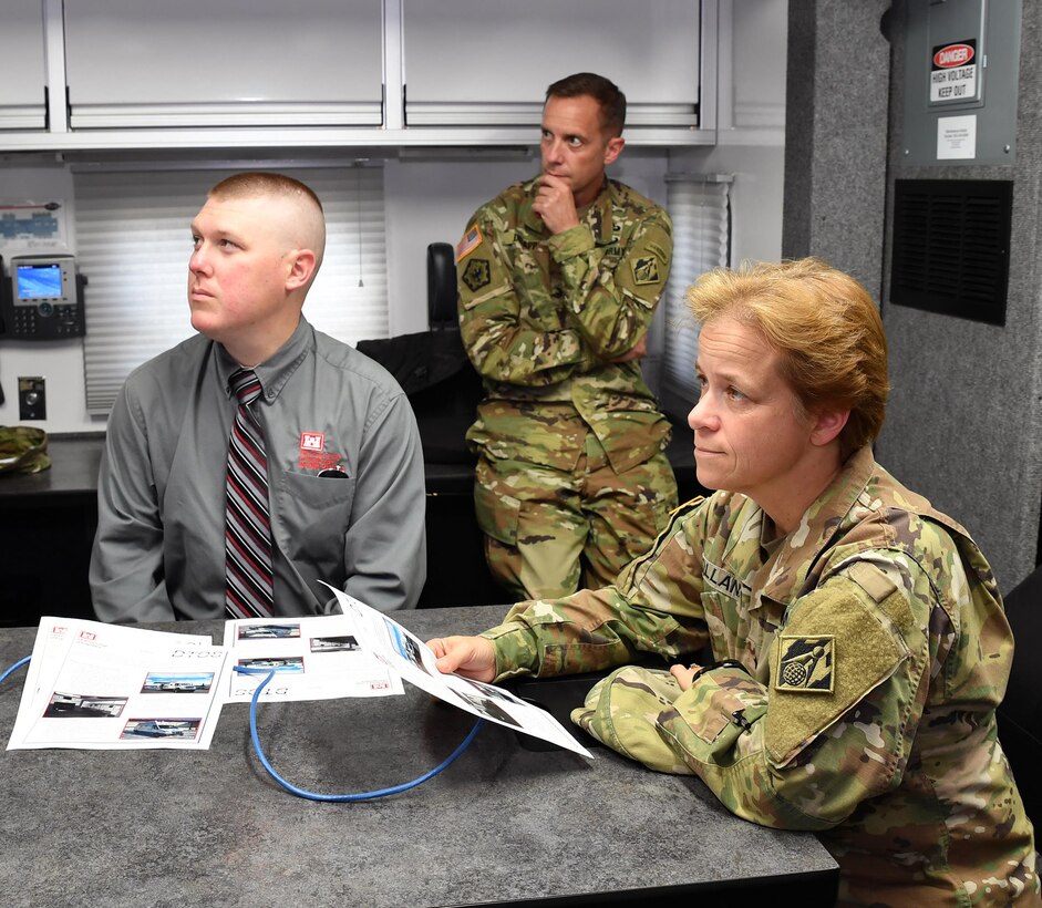 South Atlantic Division Commander Brig. Gen. Diana Holland and district officials received a briefing on Mobile District Deployable Tactical Operation System, or DTOS, capabilities by Terrell Bosarge, DTOS national team leader, not pictured. From left are: Eric North, district training officer; Col. James DeLapp, district commander; and Brig. Gen. Diana Holland, division commander. (Photo by John Barker)