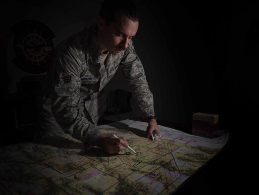 U.S. Air Force Senior Airmen John Hartin, 94th Fighter Squadron all source intelligence analyst, maps out ground-to-air target scenarios for Red Flag 17-4 mission planning at Nellis Air Force Base, Nev., Aug. 23, 2017. Utilizing intelligence from multiple sources, Hartin plots out each target point for the pilots’ awareness allowing them to execute a mission. (U.S. Air Force photo by Staff Sgt. Carlin Leslie)