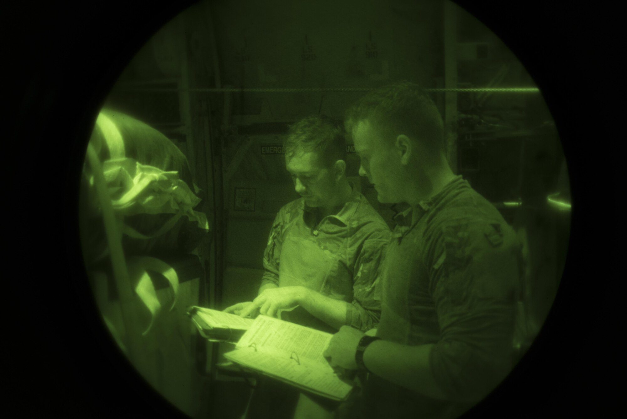 Senior Airmen Tom Saunders, left, and Jacob Snider, 774th Expeditionary Airlift Squadron loadmasters, review a checklist while preparing for an airdrop at Kandahar Airfield, Afghanistan, Aug. 24, 2017. An airdrop is one of many methods airlift Airmen use to deliver cargo. When planning on how to deliver cargo, the type of environment is a key factor in the decision. Weather, the danger present in the area and terrain are just a few of the factors used in deciding what method to use. (U.S. Air Force photo by Staff Sgt. Benjamin Gonsier)