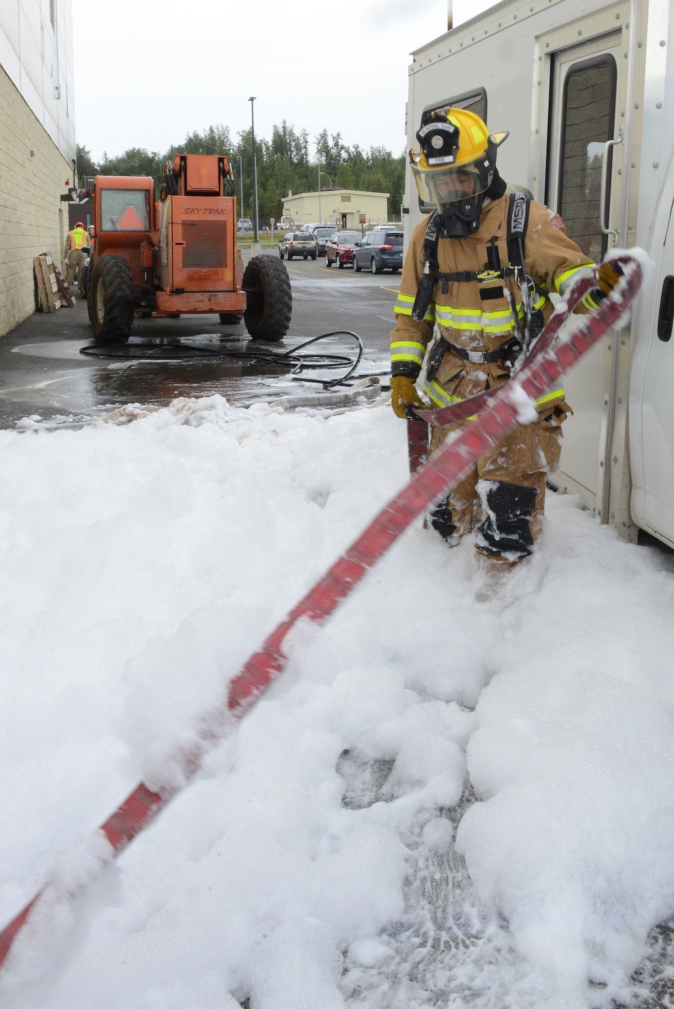 Firefighters assigned to the 673d Civil Engineer Squadron train during the high-expansion foam test at Hangar 18 on Joint Base Elmendorf-Richardson, Alaska, Aug. 31, 2017. The firefighters were a part of the foam test to practice and train for rescue operations. (U.S. Air Force photo by Airman 1st Class Caitlin Russell)