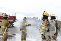 Firefighters assigned to the 673d Civil Engineer Squadron train during the foam test at Hangar 18 on Joint Base Elmendorf-Richardson, Alaska, Aug. 31, 2017. The firefighters were a part of the foam test to practice and train for rescue operations. (U.S. Air Force photo by Airman 1st Class Caitlin Russell)