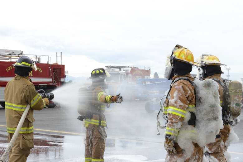 Firefighters assigned to the 673d Civil Engineer Squadron train during the foam test at Hangar 18 on Joint Base Elmendorf-Richardson, Alaska, Aug. 31, 2017. The firefighters were a part of the foam test to practice and train for rescue operations. (U.S. Air Force photo by Airman 1st Class Caitlin Russell)