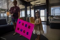 Kaitlyn O'Rear, 3, and her mom show off their "free hugs" sign, Sept. 2, 2017, at Easterwood Airport in College Station, Texas. The local community gathered and offered support in the form of food, drinks, and company to military members staging out of the airport for search and rescue operations.  (U.S. Air Force photo by Tech. Sgt. Zachary Wolf)