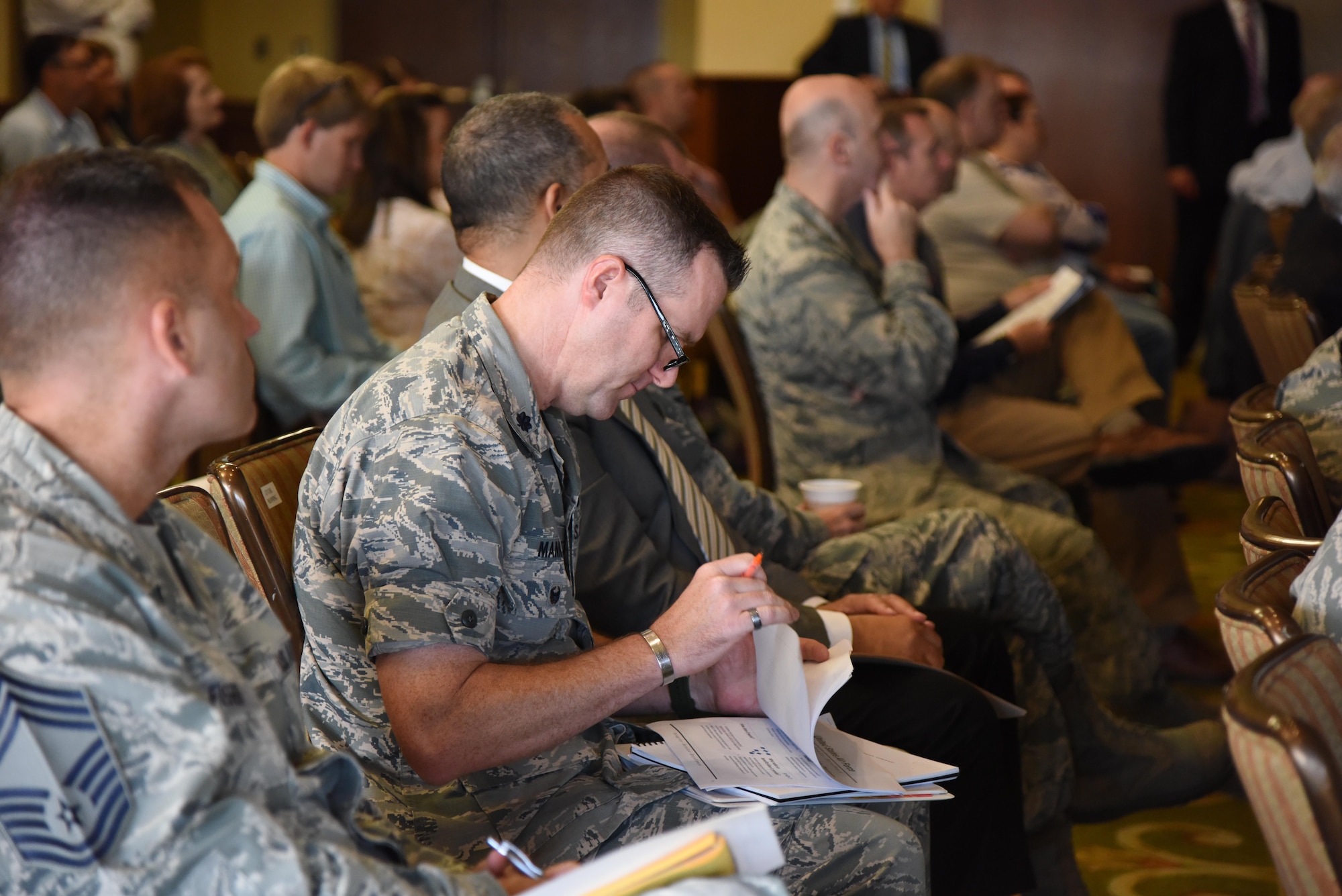 Lt. Col. Michael Manning, 81st Training Group deputy commander, reviews printed slides during the Air Force Community Partnership Program Priorities Workshop at the Bay Breeze Event Center Aug. 31, 2017, on Keesler Air Force Base, Mississippi. After members from Keesler and the local community developed creative ways to leverage capabilities, resources and reduce costs in their last meeting, they shared their ideas to achieve mutual value and benefit in support of the Air Force and its business partners. (U.S. Air Force photo by Kemberly Groue)