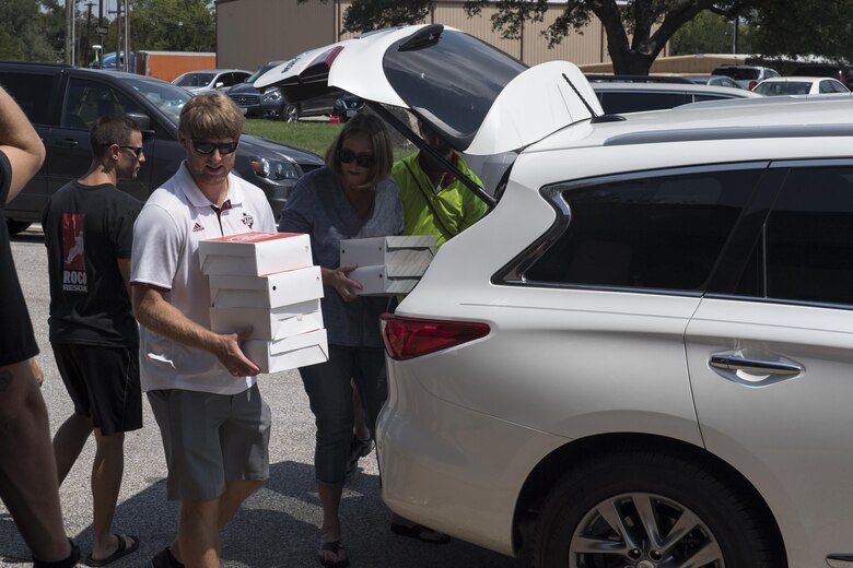 Volunteers from the local community unload food, Sept. 2, 2017, at Easterwood Airport in College Station, Texas.