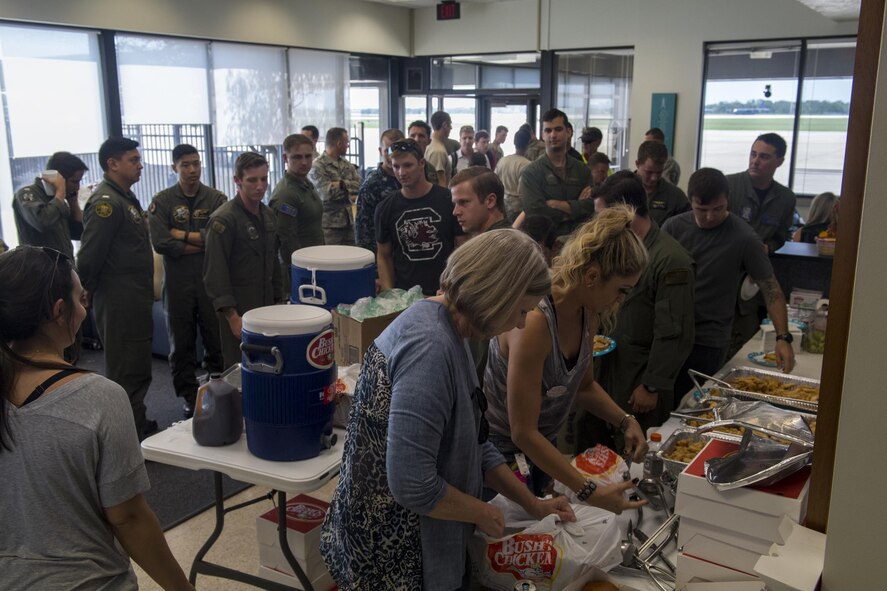 Volunteers set up food as military members gather, Sept. 2, 2017, at Easterwood Airport in College Station, Texas.