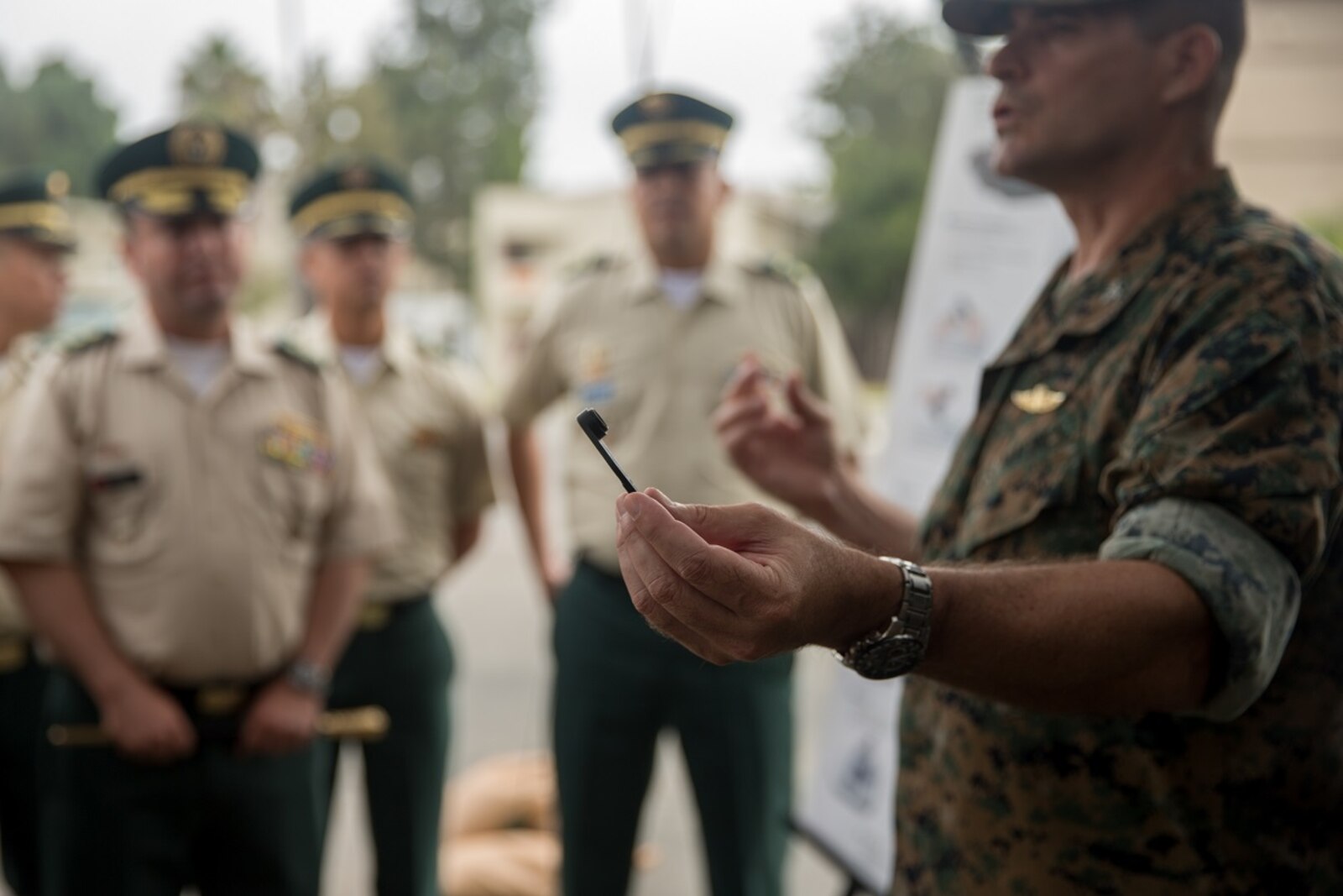 U.S. Marine Corps Col. Jaime Collazo, the commanding officer of Combat Logistics Regiment 15, 1st Marine Logistics Group, presents a cobra helmet racket to the students from the Columbian War College’s General Staff Course at Camp Pendleton, Calif., Sept. 6, 2017. In addition to the War College’s academic master’s program, the school offers specialist degrees in security and national defense, command and general-staff studies, and the promotion courses for high-ranking military officers. (U.S. Marine Corps photo by Lance Cpl. Roderick Jacquote)