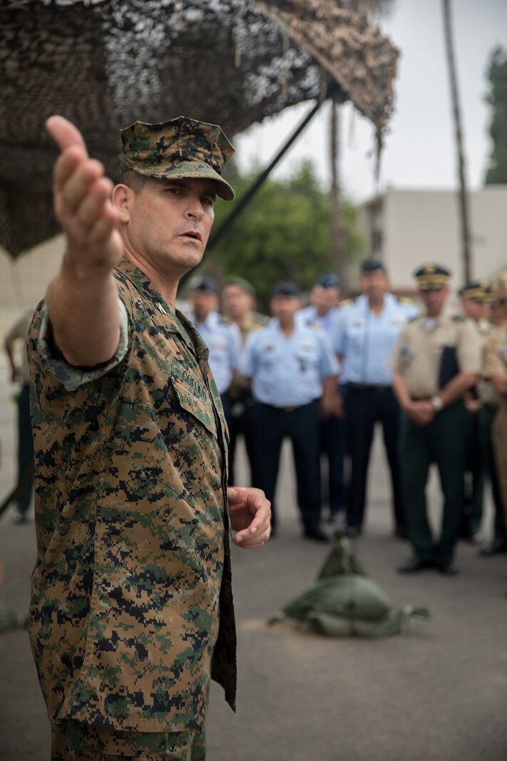 U.S. Marine Corps Col. Jaime Collazo, the commanding officer of Combat Logistics Regiment 15,1st Marine Logistics Group, describes a static display to the students from the Columbian War College’s General Staff Course at Camp Pendleton, Calif., Sept. 6, 2017. The students observed parts of the U.S. military strategic war-time contingencies to apply this knowledge to their units. (U.S. Marine Corps photo by Lance Cpl. Roderick Jacquote)