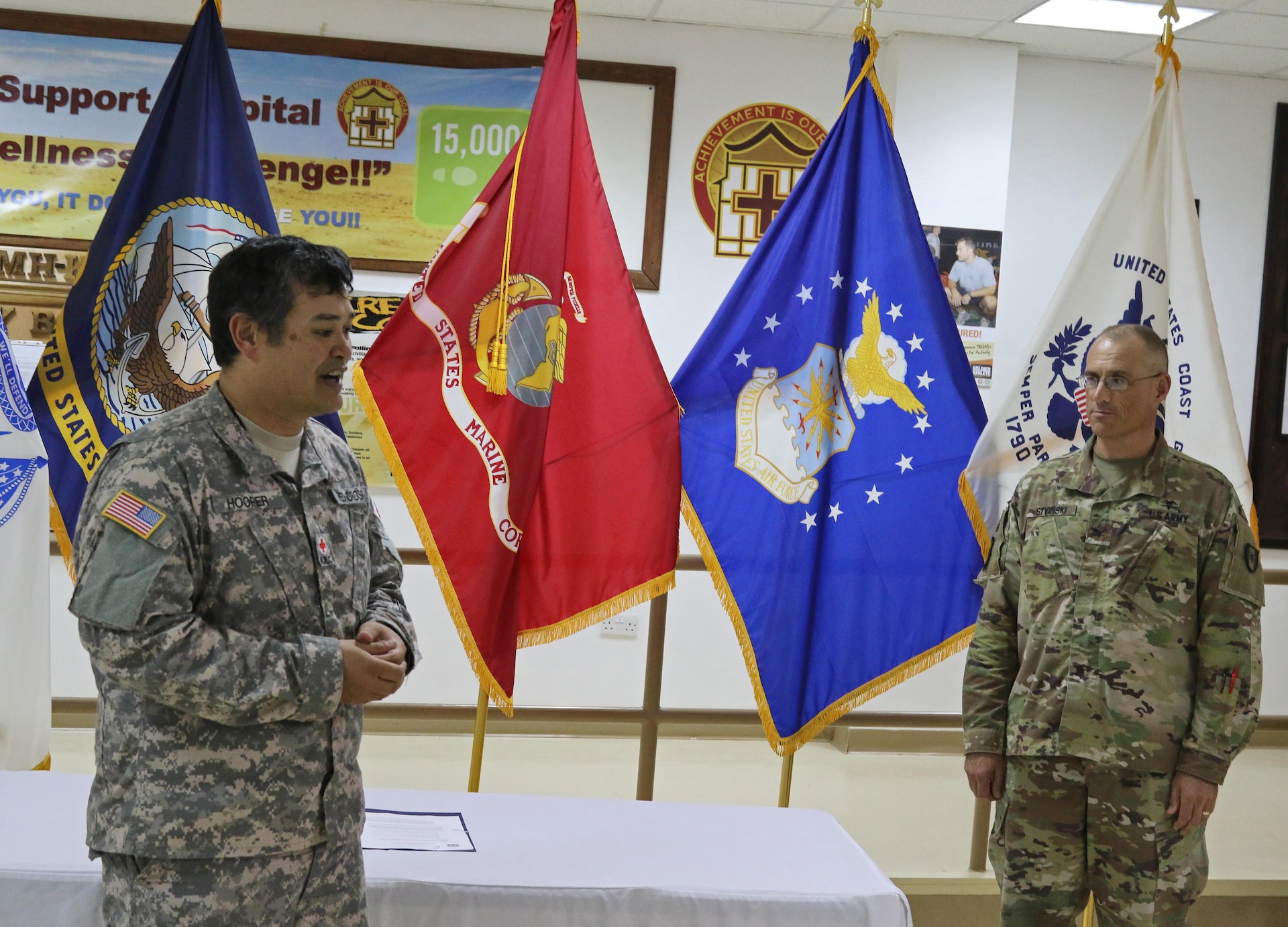Two soldiers speaking to an out-of-frame audience.