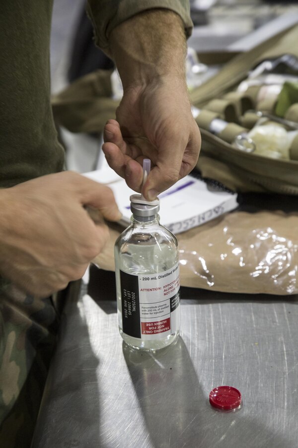 Critical skills operators with U.S. Marine Corps Forces, Special Operations Command train with freeze-dried plasma during a Raven pre-deployment exercise at Camp Shelby Joint Force Training Center, Miss., May 1, 2017.  CSOs go through a condensed version of FDP training to familiarize themselves with the product for use in the field. (U.S. Marine Corps photo by Sgt. Salvador R. Moreno)