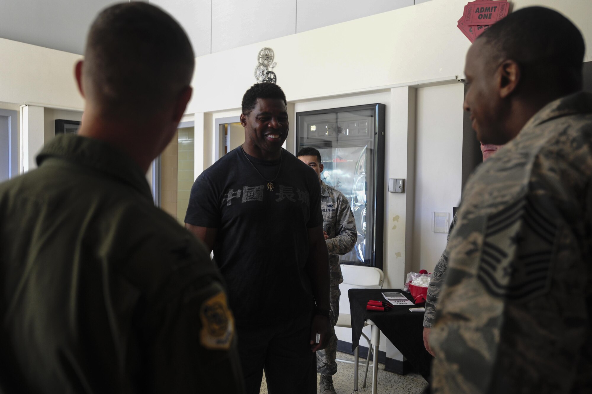 Herschel Walker, former professional football player, greets Col. Kevin Gordon, 15th Wing commander, and Chief Master Sgt. Michael Cole, 15th Wing command chief,  before talking with Airmen about the importance of mental health care at the Hickam Memorial Theatre, Joint Base Pearl Harbor-Hickam, Hawaii, Sep. 6, 2017.