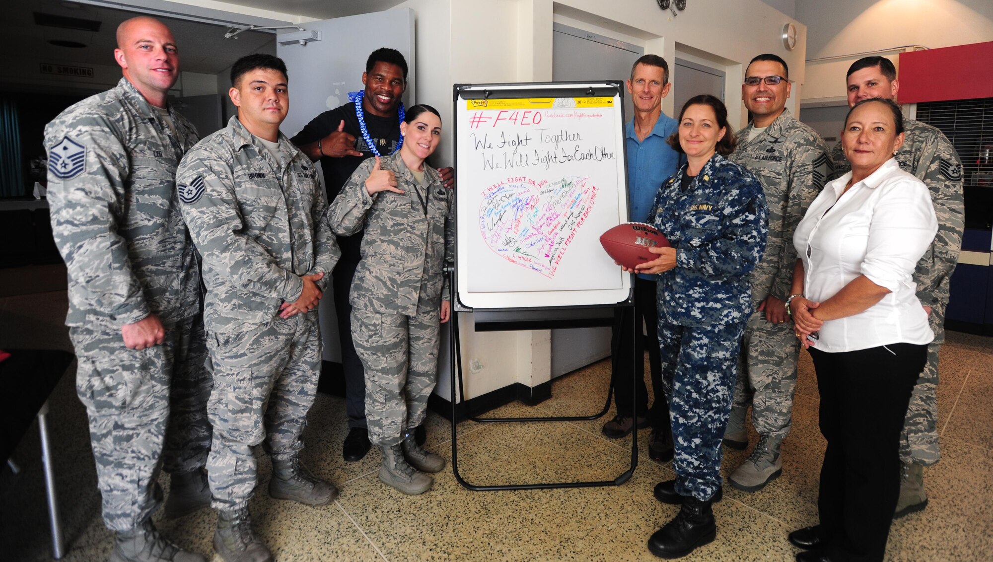 Herschel Walker, former professional football player, poses with the Fight For Each Other event coordinators after talking with Airmen about the importance of mental health care at the Hickam Memorial Theatre, Joint Base Pearl Harbor-Hickam, Hawaii, Sep. 6, 2017.