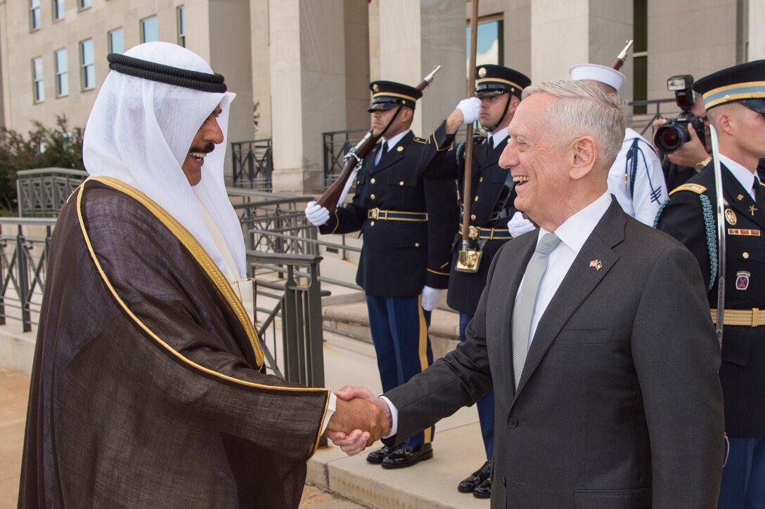 Defense Secretary Jim Mattis shakes hands with his Kuwaiti counterpart at the Pentagon.