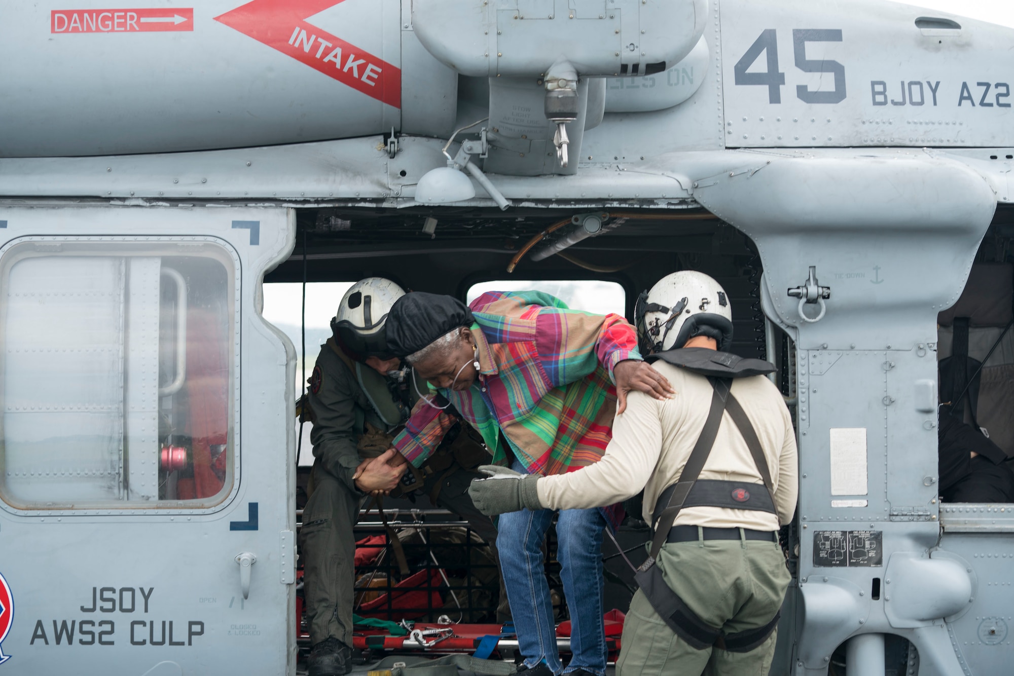 Naval Aircrewman (Helicopter) 2nd Class Jansen Schamp (Left) and Naval Aircrewman (Helicopter) 2nd Class Rion Johnson,  both assigned to the Dragon Whales of Helicopter Sea Combat Squadron (HSC) 28, assist with a medical evacuation during Hurricane Harvey relief efforts.  The Western Air Defense Sector provided critical communications relay between the Texas Emergency Operations Center and the U.S. Navy that rescued over 100 people from the school grounds.  (U.S. Navy Photo by Mass Communication Specialist 1st Class Christopher Lindahl)