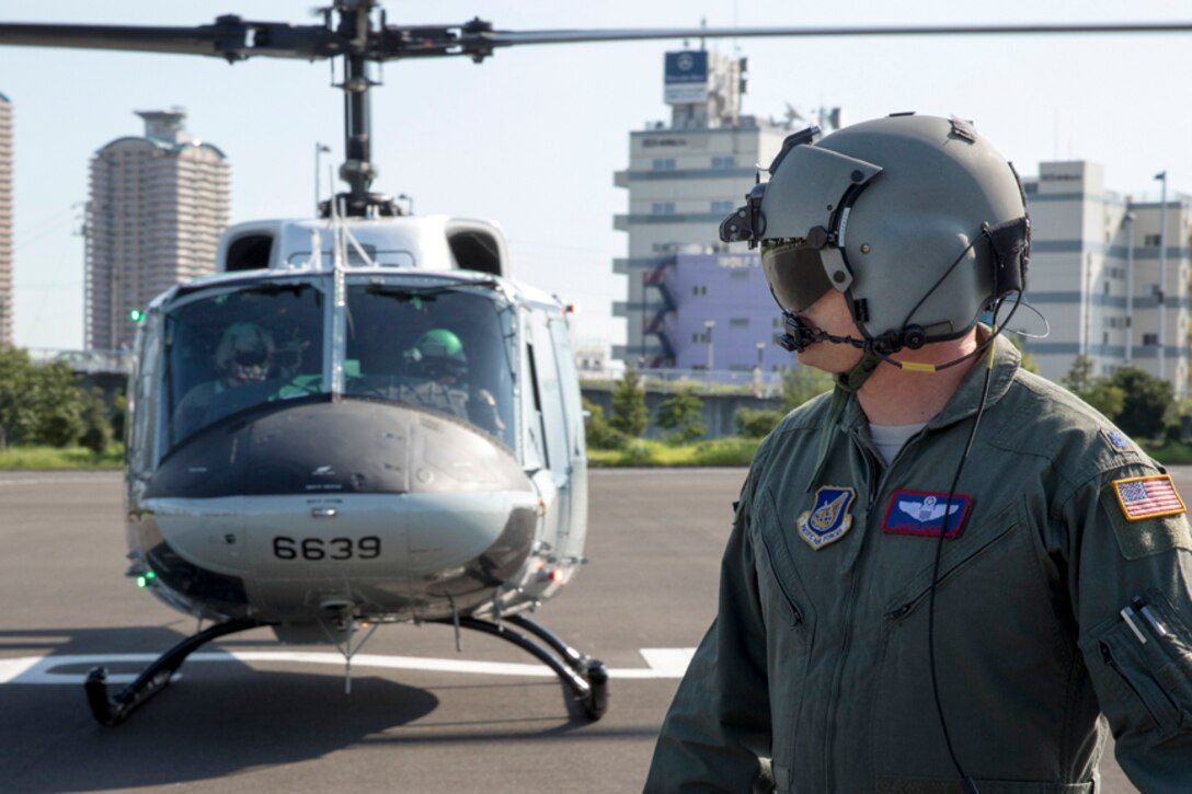 Lt. Col. Scott Adams, 459th Airlift Squadron director of operations, waits for members with the Tokyo Metropolitan Government to bring simulated disaster relief supplies to a UH-1N Iroquois
