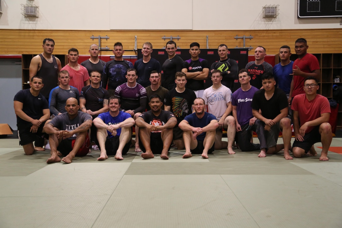 Marines and mixed martial arts fighters pose for a picture