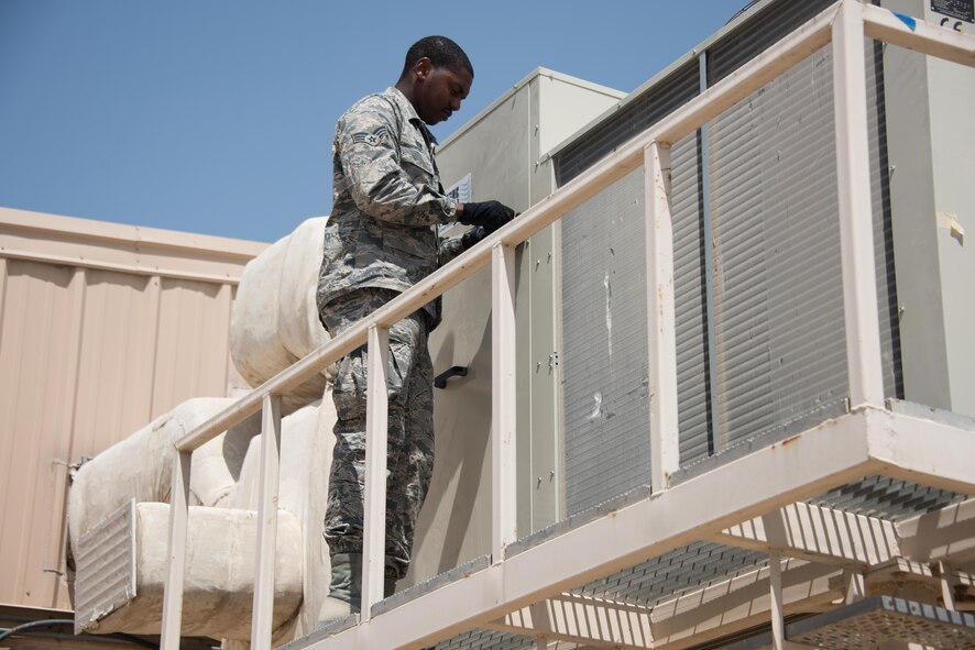 Senior Airman Jonathon Dow, a heating, ventilation and air conditioning journeyman with the 386th Expeditionary Civil Engineer Squadron, secures the side cover of an air conditioning unit at an undisclosed location in Southwest Asia, Wednesday, Aug. 23, 2017. Whether conducting preventative maintenance or responding to needed repairs these dedicated technicians beat the heat and keep cool under pressure as they keep up with daily demands. (U.S. Air Force photo by Tech. Sgt. Jonathan Hehnly)