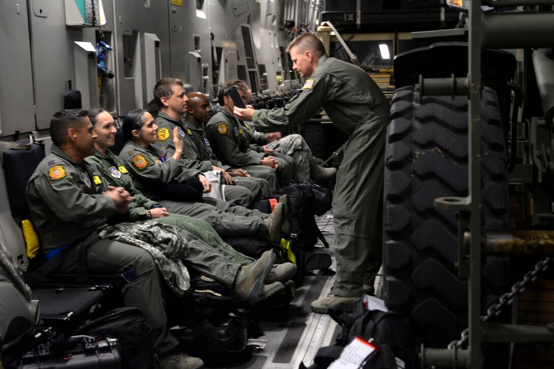 Airmen take photos inside a C-17 Globemaster III at Travis Air Force Base
