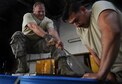 Tech. Sgt. Ryan Price, the 86th Logistics Readiness Squadron air delivery supervisor, pulls chords to tighten an airdrop bundle on Otopeni Air Base, Romania, Aug. 29, 2017. Aerial delivery Airmen, commonly known as riggers, are responsible for securing bundles and correctly rigging parachutes in order to ensure proper opening of the former. (U.S. Air Force photo by Airman 1st Class Joshua Magbanua)