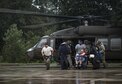 Airmen and Soldiers assist victims out of a UH-60 Black Hawk, Aug. 30, 2017, at the Orange County Convention and Expo Center in Orange, Texas. The 347th and 563rd Rescue Groups from Moody Air Force Base, Ga., Nellis AFB, Nev., and Davis-Monthan AFB, Ariz., sent rescue boat teams to Orange County, Texas, and the surrounding areas in support of the Federal Emergency Management Agency during Hurricane Harvey disaster response efforts. (U.S. Air Force photo by Staff Sgt. Ryan Callaghan)