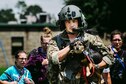 Senior Airman Austin Hellweg, a 129th Rescue Squadron special missions aviator, carries a dog and leads a family into an HH-60 Pavehawk for extraction to a safer location during the relief effort for Hurricane Harvey, Aug. 31, 2017, at Beaumont, Texas. The relief efforts have a conglomerate of active duty, Air National Guard and reserve units from all branches aiding the federal government to help Texas recover from Hurricane Harvey. (U.S. Air Force photo by Staff Sgt. Jordan Castelan)