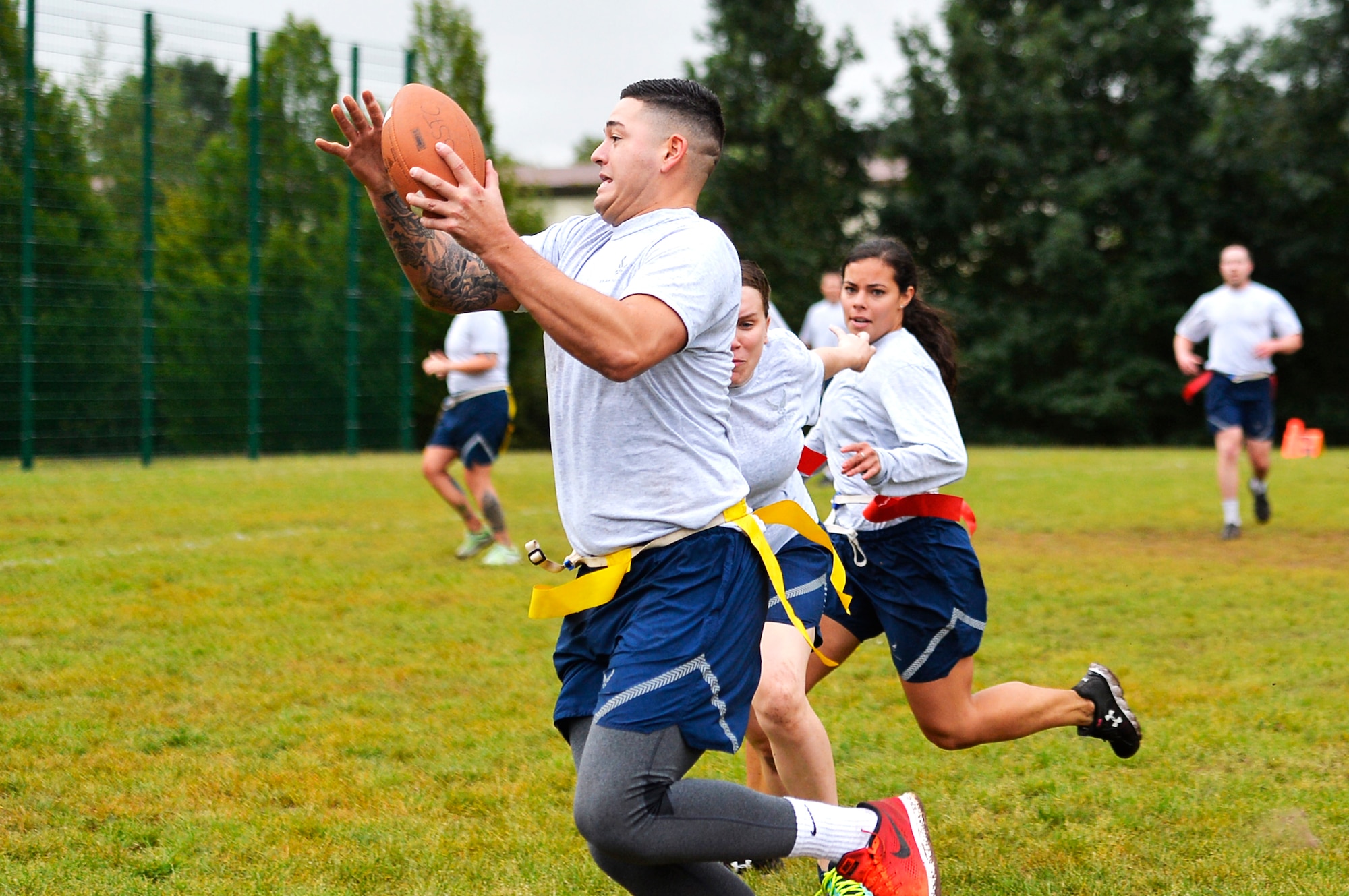 U.S. Airmen assigned to the 86th Airlift Wing play flag football on Ramstein Air Base, Germany, Sept. 6, 2017. Airmen from all over the wing competed in the annual Commander’s Challenge resiliency day. (U.S. Air Force photo by Airman 1st Class Joshua Magbanua)